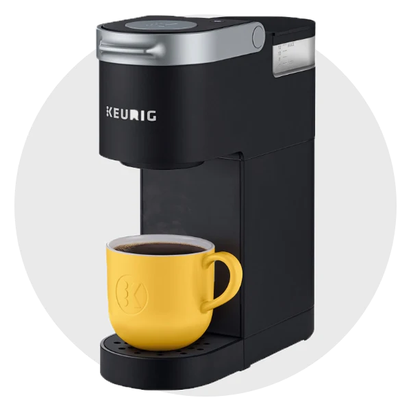 Keurig single-serve coffee maker brewing into a yellow mug – compact home appliance in the housewares collection
