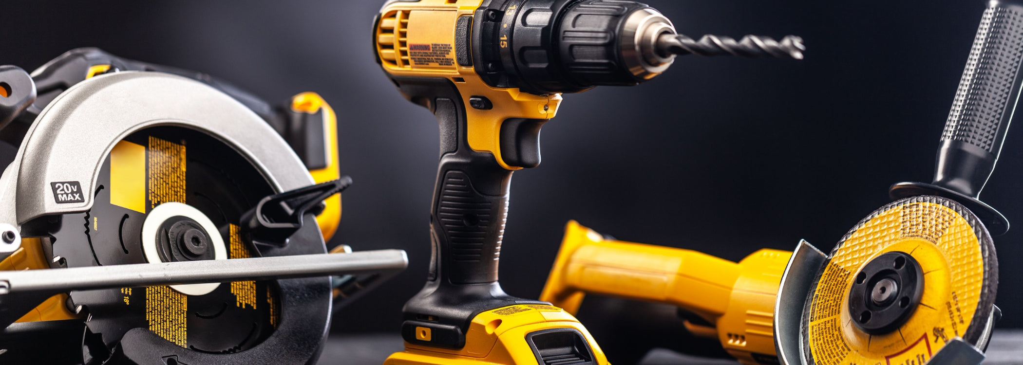 Yellow and black cordless power tools including drill, circular saw, and angle grinder – professional power tools for construction and woodworking
